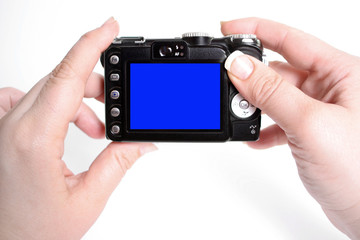 woman's hands hold camera with blank screen,