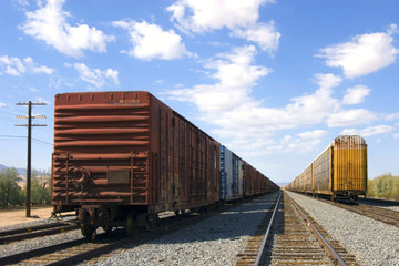 Obraz premium parked railroad freight cars sitting on tracks in desert