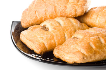 Fresh rolls on a plate on a white background