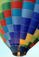 Obraz premium Propane burners being fired in a colourful hot air balloon.