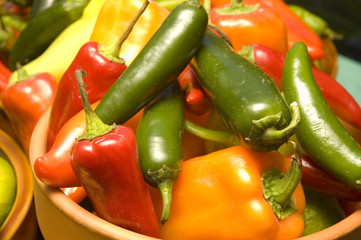 a bowl of red, green, and yellow peppers