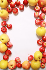 Yellow and red apples against the white background