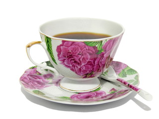 Porcelain cup to tea, a saucer and a spoon. Isolated.