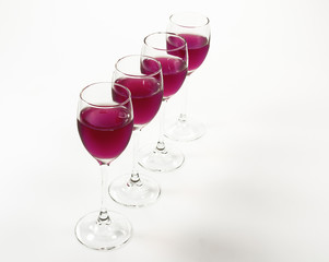 Cognac glasses on white background filled with wine