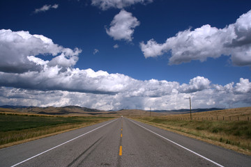 Straight road in Canadian prairie. Landscape of Alberta.