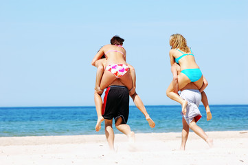 Young attractive friends having fun the summer beach