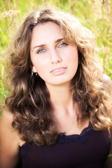 Naklejka premium Young woman on a summer field.