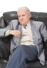 Portrait of a senior man sitting in an armchair