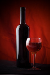 Red wine glass and bottle