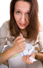 confused and upset woman is tearing some documents