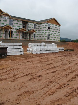 apartment building under construction with earthwork
