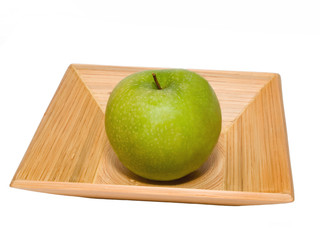 fresh green apple on the pressed bamboo dish