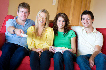 Four young adults having fun at home