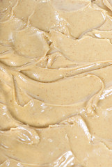 A close up of some creamy peanut butter on bread.