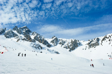 Skiers on a piste at Courchevel ski resort, French Alps