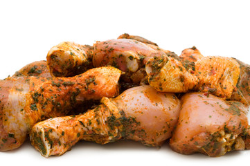 Raw chicken drumsticks on white background