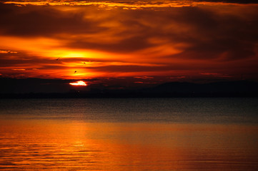 watching a sunset on the calm water