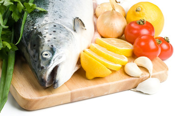 Fresh raw salmon with vegetables on a white background