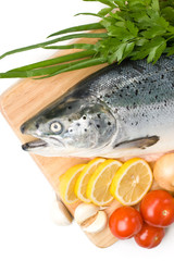 Fresh raw salmon with vegetables on a white background
