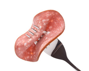 Sausage on a fork on a white background