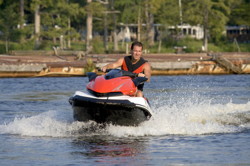 Man riding wave runner on a beautiful summer day.