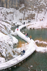 Plitvice - winter landscape with lake, path and some tourists