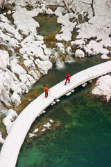Plitvice - winter landscape with lake, path and some tourists