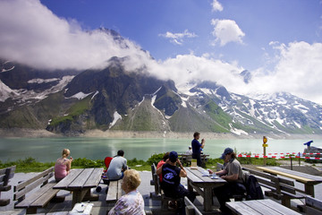 Tourists enjoying the view at lake Moserboden in Kaprun