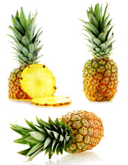 set of fresh ripe pineapples close up over white