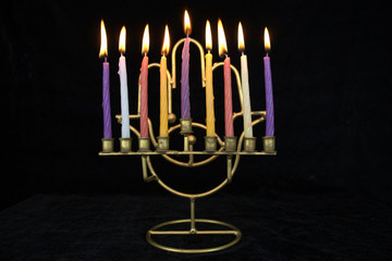 Fototapeta premium hanukiah with all the candles burning on black background