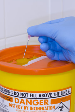 Safe Disposal Of A Needle Into A Sharps Container