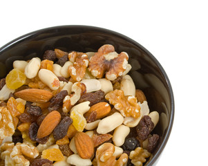 Fruit and Nut mix in black serving bowl over white background