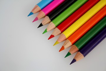 Colorful pencils on a white paper