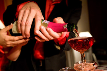 the bride and groom pouring champagne on their wedding ceremony