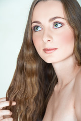 Fototapeta premium Beautiful brunette girl in early twenties with natural make-up
