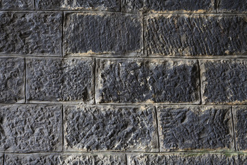 backgroud of ashlar masonry covered carbon-black
