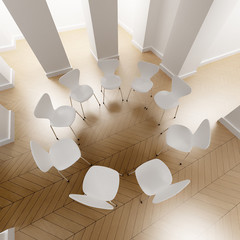 Aerial shot of a circle of white chairs in a room