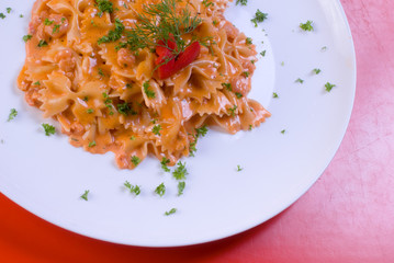 macaroni decorated with fresh green herbs