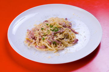 freshly cooked plate of spaghetti with ham and cheese