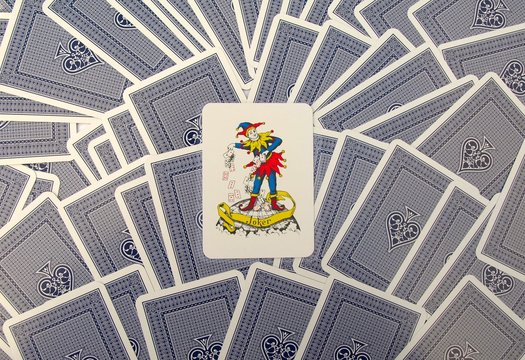 Joker card with blue playing cards.
