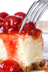 A delicious slice of cheesecake with fruit topping.