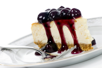 A delicious slice of cheesecake with fruit topping.