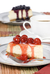 A delicious slice of cheesecake with fruit topping.