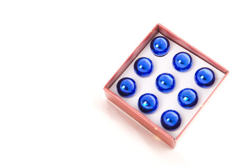 Box of blue christmas balls on the white background