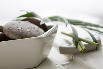 Brown massage stones in white bowl
