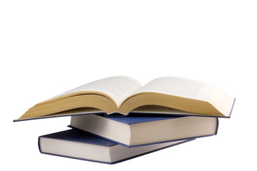 Open book lying on other books