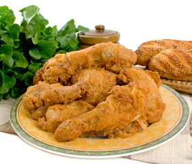 Fried chicken pieces over white background