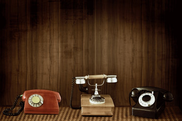 Three classic old phones on grunge background