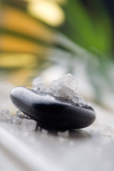 White bath salt on black massage stone