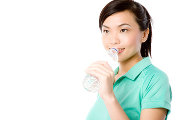 A young attractive Asian woman in sportswear with water